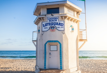 Laguna Beach California Lifeguard tower standing tall on a sandy beach, overlooking the vast ocean.